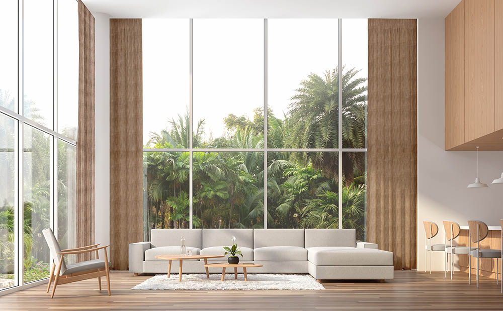 Modern contemporary high ceiling living room 3d render.The Rooms have wooden floors,white and wood wall.furnished with white fabric furniture.There are large window. Overlooks to palm garden.